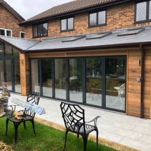 Previous Conservatory removed & replaced with natural cedar clad extension with aluminium glazing & patios doors.